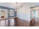 Bright dining room with hardwood floors, modern chandelier, and french doors to kitchen at 109 Ayesha Ln, Henderson, NV 89074