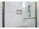 Glass-enclosed shower with white subway tile and decorative tile accent niche at 109 Ayesha Ln, Henderson, NV 89074