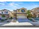 Two-story house with beige siding, gray shutters, and a brick walkway at 11857 Corenzio Ave, Las Vegas, NV 89138