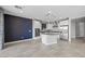 Modern kitchen with white cabinets, gray island, and stainless steel appliances at 11857 Corenzio Ave, Las Vegas, NV 89138