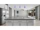 Modern kitchen island with gray countertop and white cabinets at 11857 Corenzio Ave, Las Vegas, NV 89138