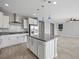 Modern kitchen with island, stainless steel appliances, and gray backsplash at 11857 Corenzio Ave, Las Vegas, NV 89138