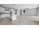 Modern kitchen with white cabinets, gray island, and stainless steel appliances at 11857 Corenzio Ave, Las Vegas, NV 89138