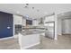 Modern kitchen with white cabinets, gray island, and stainless steel appliances at 11857 Corenzio Ave, Las Vegas, NV 89138