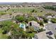 An aerial view of a house with a pool, solar panels and a green landscape at 1327 Coulisse St, Henderson, NV 89052