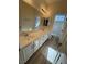 Double vanity bathroom with light wood floors at 1327 Coulisse St, Henderson, NV 89052