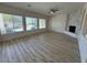 Living room with hardwood floors, fireplace, and pool view at 1327 Coulisse St, Henderson, NV 89052