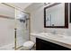 A bathroom with glass shower, sink, commode and framed mirror at 1600 N Torrey Pines Dr # 202, Las Vegas, NV 89108