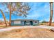 Ranch style home with blue exterior, landscaping, and long driveway at 1620 Leonard Ln, Las Vegas, NV 89108