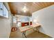 Long hallway with light walls and a wooden folding table at 1620 Leonard Ln, Las Vegas, NV 89108