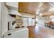 Vintage kitchen with white cabinets, stove, and wood flooring at 1620 Leonard Ln, Las Vegas, NV 89108