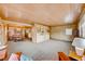 Open living and dining area with wood paneling and carpeted floors at 1620 Leonard Ln, Las Vegas, NV 89108