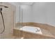 Relaxing bathroom with a large soaking tub and glass shower at 1837 Birdie Ln, Henderson, NV 89074