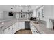 Modern white kitchen with granite countertops and stainless steel appliances at 1837 Birdie Ln, Henderson, NV 89074