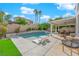 Relaxing pool area with patio furniture and lush landscaping at 1837 Birdie Ln, Henderson, NV 89074