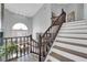 Elegant staircase with dark wood railings leading to upper level at 1837 Birdie Ln, Henderson, NV 89074