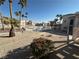 View of a community pool area with palm trees and building in background at 1944 Las Palmas Ln # 175, Laughlin, NV 89029