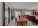 Dining area with a rustic wood table, black framed mirrors, and stylish seating at 2090 Lewiston Pl, Henderson, NV 89044