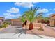 Single-story home with desert landscaping, two palm trees, and a two-car garage at 2090 Lewiston Pl, Henderson, NV 89044