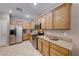 Well-equipped kitchen with wood cabinets and tile flooring at 2090 Lewiston Pl, Henderson, NV 89044