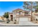 Two story house with tan exterior, brown roof, and a two car garage at 2153 Eaglecloud Dr, Henderson, NV 89074