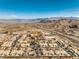 An aerial view of a large community with multiple homes, roads, and mountain views at 225 Big Horn Dr # 5, Boulder City, NV 89005