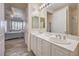 Bathroom with double vanity and view into bedroom at 225 Big Horn Dr # 5, Boulder City, NV 89005