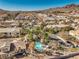 An aerial view of a community pool surrounded by palm trees and residential buildings at 225 Big Horn Dr # 5, Boulder City, NV 89005