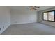 Large bedroom featuring carpet, a ceiling fan and large window at 2250 Shaw Cir, Las Vegas, NV 89117