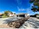 House exterior showcasing a two-car garage and a long driveway at 2250 Shaw Cir, Las Vegas, NV 89117