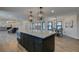 Large kitchen island with granite countertops and dark cabinets at 2250 Shaw Cir, Las Vegas, NV 89117