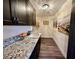 Bright laundry room with granite countertops and dark cabinetry at 2250 Shaw Cir, Las Vegas, NV 89117