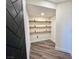 Small room with dark wood herringbone door and floating shelves at 2250 Shaw Cir, Las Vegas, NV 89117