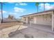 Spacious backyard with covered patio, storage shed, and block wall at 2318 Howard Dr, Las Vegas, NV 89104