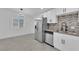 Bright kitchen with stainless steel appliances and white cabinets at 2318 Howard Dr, Las Vegas, NV 89104