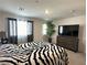 Bright bedroom with large windows, zebra print comforter, and a dresser at 2853 Tahiti Grape Way # 3, Las Vegas, NV 89183