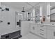 Modern bathroom with double vanity, marble tile, and a large walk-in shower at 3105 Siena Cir, Las Vegas, NV 89128