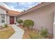 Front entry with red door and landscaping at 3105 Siena Cir, Las Vegas, NV 89128