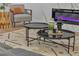 Living area with gray arm chair and black nesting coffee tables at 3105 Siena Cir, Las Vegas, NV 89128