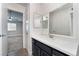 Bathroom with dark vanity and a large mirror at 312 Crosswind Way, Las Vegas, NV 89145