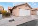 Attached single car garage with a white door and neutral colored exterior at 312 Crosswind Way, Las Vegas, NV 89145