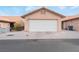 Attached single car garage with a white door and neutral colored exterior at 312 Crosswind Way, Las Vegas, NV 89145