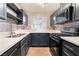 Modern kitchen with stainless steel appliances and dark cabinets at 312 Crosswind Way, Las Vegas, NV 89145