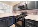 Modern kitchen with stainless steel appliances and dark cabinets at 312 Crosswind Way, Las Vegas, NV 89145