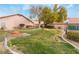 Community lawn area with a tree and landscaping at 312 Crosswind Way, Las Vegas, NV 89145