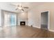 Living room with fireplace, wood-look floors and door to bedroom at 312 Crosswind Way, Las Vegas, NV 89145