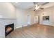 Living room with fireplace, wood-look floors and view of kitchen at 312 Crosswind Way, Las Vegas, NV 89145