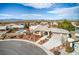 Aerial view of the home shows desert landscaping and an in-ground pool with a mountain backdrop at 3540 E Burgundy Dr, Pahrump, NV 89048