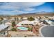 Aerial view of a home with desert landscaping, in-ground pool, and surrounding mountain views at 3540 E Burgundy Dr, Pahrump, NV 89048