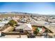 Expansive aerial view of a charming desert home, sparkling pool, and desert landscaping with mountain views at 3540 E Burgundy Dr, Pahrump, NV 89048